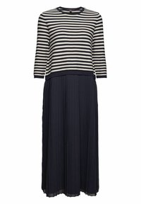 Randig långärmad topp i marinblått och krämfärgat, i kombination med en enfärgad marinblå veckad kjol. Tyget verkar slätt med en flödande silhuett.