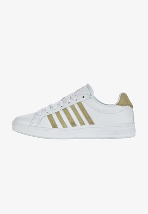 White sneaker made of synthetic material with golden accents. Features lacing, five stripes on the side, and a textured sole.