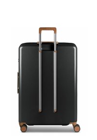 Valigia dura nera con due maniglie argentate, dettagli in bronzo e quattro ruote. Superficie liscia e forma rettangolare con design minimale.