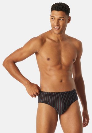 Slip da bagno neri con righe verticali multicolori, caratterizzati da un tessuto liscio ed elastico e un design classico e aderente.