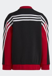 Black and red sweatshirt with a ribbed red collar. Features three white and black stripes across the back and red side panels. Soft fabric.