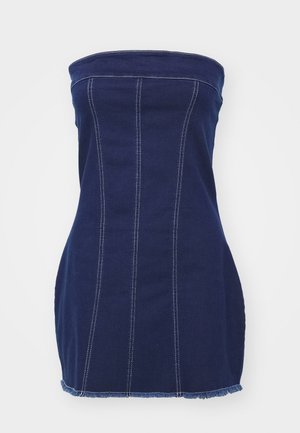 Tengerészkék farmer pánt nélküli ruha függőleges varrással, szakadozott szegéllyel és kontrasztos fehér öltések. A testhez álló fazon hangsúlyozza a sziluettet.