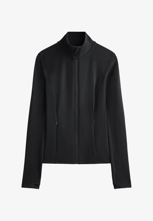 Veste softshell noire avec un col montant, fermeture éclair complète, deux poches latérales et une texture lisse. Design ajusté avec des détails de couture.