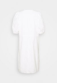 White dress with puffed sleeves, featuring a textured eyelet pattern, knee-length silhouette, and round neckline. Back view shown.