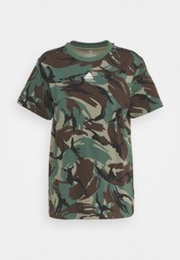 Zelené maskáčové bavlněné tričko s krátkým rukávem, kulatým výstřihem a malým bílým logem Adidas na přední straně. Má volný, pohodlný střih.