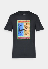 Black t-shirt featuring a colorful graphic design with blue, orange, and red sections, a Nike logo, and a pink zebra stripe pattern at the bottom.