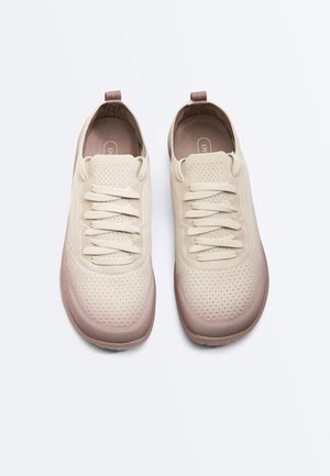 Pair of beige knitted sneakers with laces, rounded toes, and brown heel tabs, shown from above on a white background.