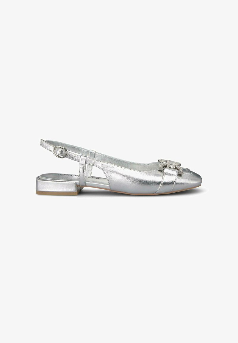 Scarpa flat slingback metallica argento con punta arrotondata, dettaglio della fibbia e tacco basso a blocco; texture liscia con bande orizzontali decorative.
