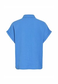 Camicetta blu a maniche corte realizzata in tessuto leggero, con una vestibilità comoda, colletto e maniche arrotolate. Superficie testurizzata senza fantasie.