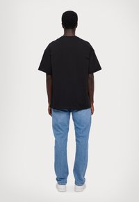 EA7 Emporio Armani UNISEX - T-shirts med print - black