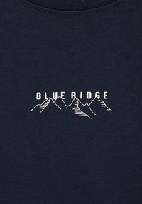 Námořnická modrá tričko s příjemným strukturovaným povrchem, na kterém je bílé nápis "BLUE RIDGE" a jednoduchá grafika hory. Kulatý výstřih.