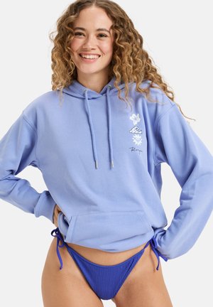 Light blue hoodie with a drawstring, front pocket, and floral designs, paired with a ribbed blue bikini bottom. Soft fabric, relaxed fit.