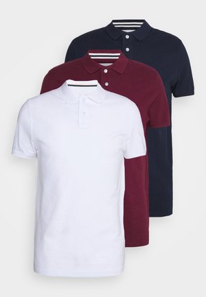 Three polo shirts stacked vertically: white, burgundy, and navy. Made of cotton with a classic collar and button closure. Striped accents on collars.