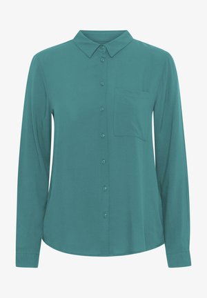 Tšintšiline pikakäised särk, mis on valmistatud siledast kangast, millel on klassikaline krae, nööbid ees ja üks rinna tasku.