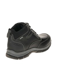 Schwarze Leder-Stiefeletten mit einem strukturierten Mesh-Obermaterial, grauen Nähdetails und einer gepolsterten Sohle. Verfügt über eine Schlaufe an der Rückseite.