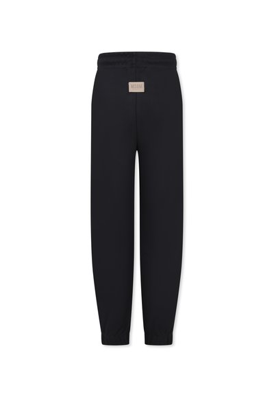 Zwarte joggingbroek met een soepele textuur, een elastische tailleband en boorden. Heeft een klein beige label op de achterkant. Het ontwerp is minimalistisch.