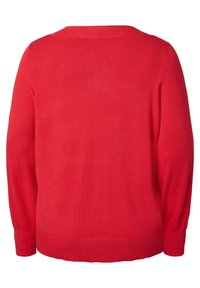 Pull rouge à manches longues, col rond, ourlet et poignets côtelés, confectionné dans un matériau tricoté lisse, présentant une couleur unie sans motifs.