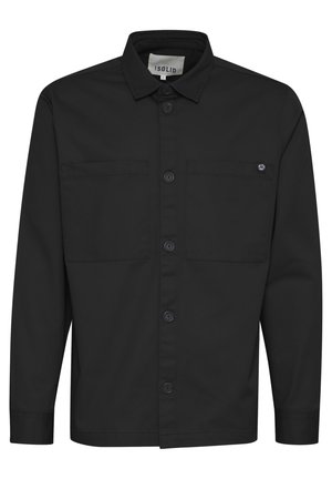 Black long-sleeve shirt featuring a button-up front, two chest pockets, and a pointed collar. Made from smooth fabric with a matte finish.