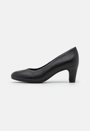 Escarpin à talon moyen en cuir noir avec bout arrondi et finition lisse, présenté de côté sur un fond clair uni.