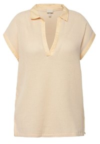 Top corto a maniche corte color beige chiaro con corpo in rete testurizzata, collo a V profondo e colletti e polsini in satin. Presenta fessure laterali per facilitare i movimenti.