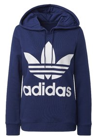 Tummansininen huppari, jossa on etutasku, valkoinen Adidas-logo ja trefoillogot, kiristettävä huppu sekä ribbaatut hihansuut ja helma.