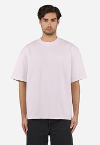 Light pink ribbed t-shirt with a crew neckline, short sleeves, and a subtle logo detail. Made of cotton for a textured look.