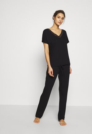 Black pajama set featuring a short-sleeve top with a lace-trimmed V-neck and drawstring pants. Soft fabric with a relaxed fit.
