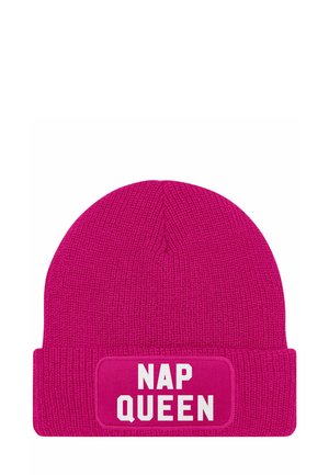 Pink knit beanie with a textured finish. Features a white "NAP QUEEN" patch on a folded cuff. Lightweight and casual design.