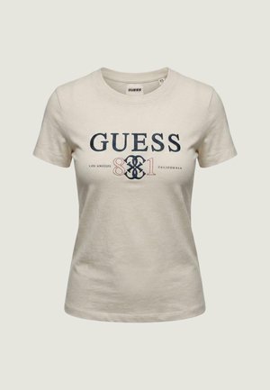 Beiges kurzärmeliges Damen-T-Shirt mit dem Aufdruck "GUESS 81 Los Angeles California" in Marineblau und Rot auf der Vorderseite.