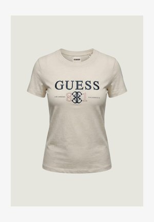 Beige short-sleeve women's T-shirt with "GUESS 81 Los Angeles California" printed in navy and red on the front.