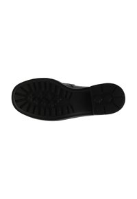 Zwarte rubberen zool met textuur voor grip, met afwisselende ribbels en kleine cirkelpatronen voor tractie. Vlakke, ronde vorm en matte afwerking.