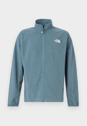 Fleece jacket in muted teal with a zip front, high collar, and the white logo on the left chest. Features long sleeves and a soft texture.
