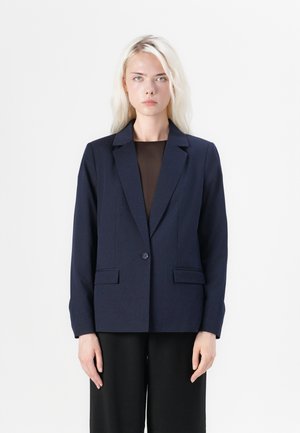 Námořnický blazer s jedním knoflíkem, klopami a dvěma předními kapsami. Střižený střih s hladkým povrchem.