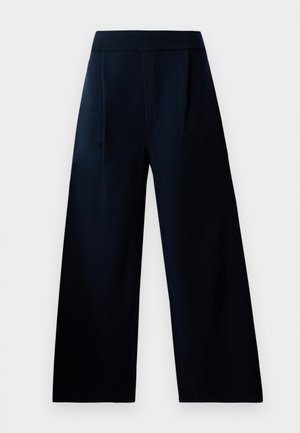 Navy wide-leg trousers with an elastic waistband, featuring two front pockets and a smooth texture, suitable for casual or formal wear.