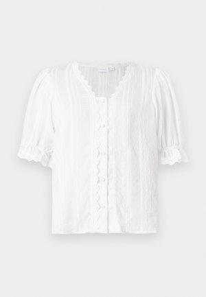 White blouse featuring puff sleeves, a scalloped neckline, and button front. Textured fabric with vertical stripes and decorative trim.
