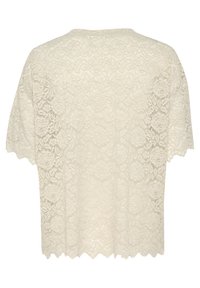 Pitkän hihattomat pitsitoppi off-white-värissä, jossa on leikattu helma, kukkakuosi ja kevyt rakenne. Avoin selkäosa.