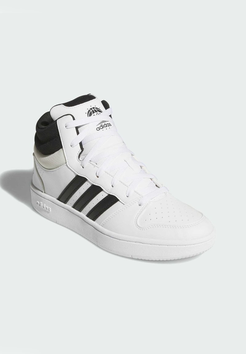 Baskets montantes blanches avec des accents noirs, présentant un design à trois bandes, une toe perforée, des lacets blancs et un soutien de cheville rembourré.