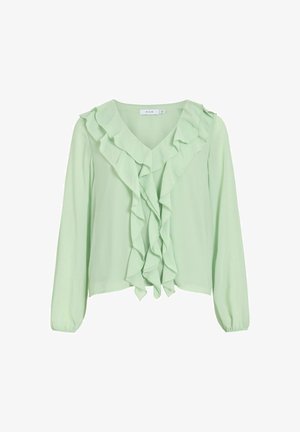 Világoszöld blúz puha anyagból, V-nyakú fazonnal, hosszú ujjakkal és díszített ráncokkal az elején. Rövidített kialakítás.