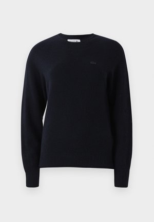 Black long-sleeve crewneck sweater with ribbed cuffs and hem, featuring a subtle embroidered logo on the left chest.