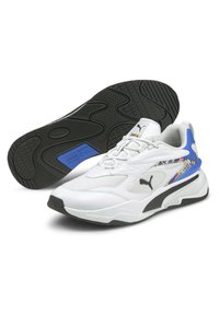 Białe sportowe sneakersy z czarną podeszwą, teksturowanymi panelami z siateczki i niebieskimi akcentami. Charakteryzują się smukłą sylwetką i wyraźnym logo.