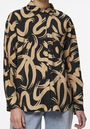 Long-sleeve button-up shirt with black base and beige abstract brushstroke pattern, worn untucked over light blue jeans.