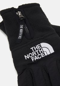 Sorte handsker lavet af fleece med en lynlåslomme. Har et fremtrædende hvidt logo på håndleddet og tekstureret greb på håndfladen.