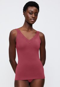 Raspberry tank top with lace trim along the V-neckline. Made from smooth fabric, it features a fitted design and thin straps.