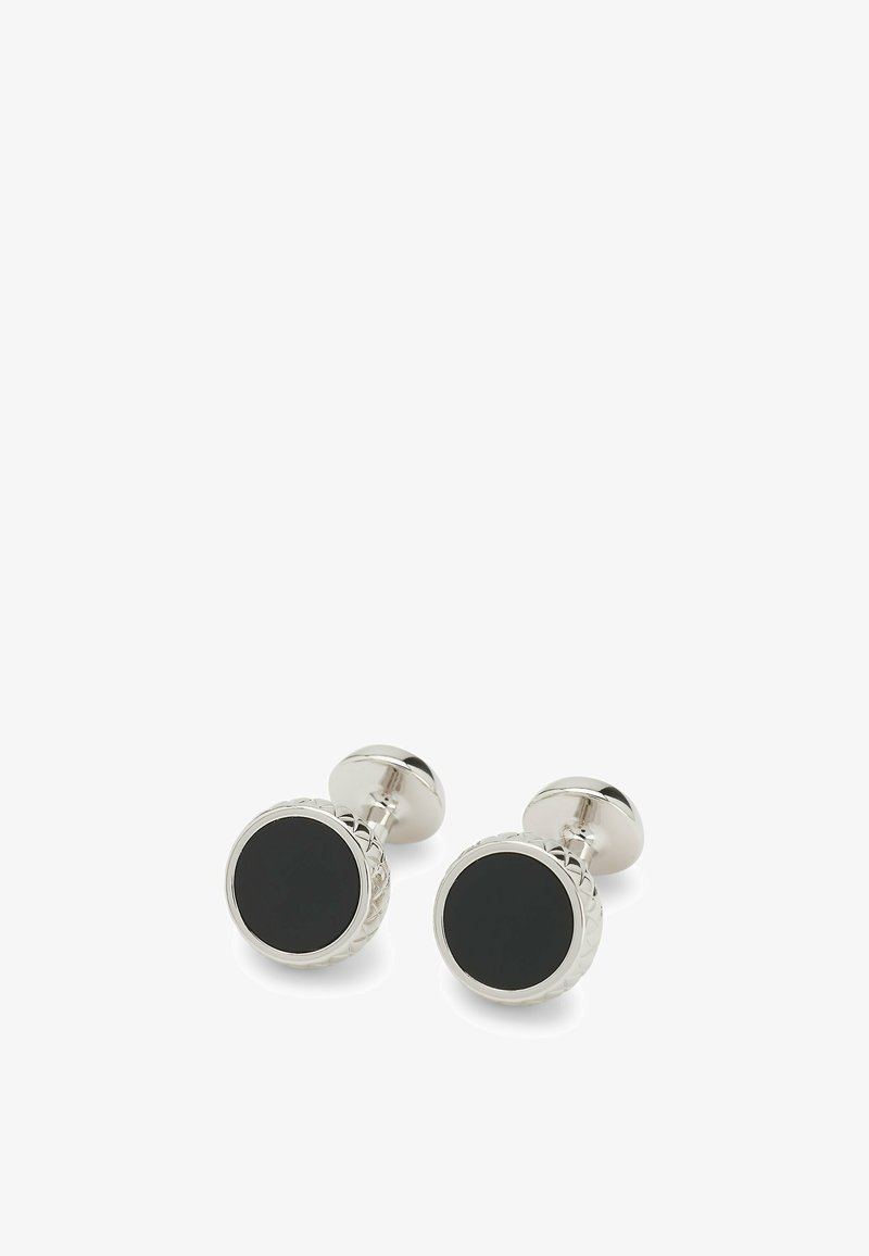 Gemelli da polso in tono argento con design circolare, centro nero, bordo texturizzato e finitura lucida per un aspetto sofisticato.