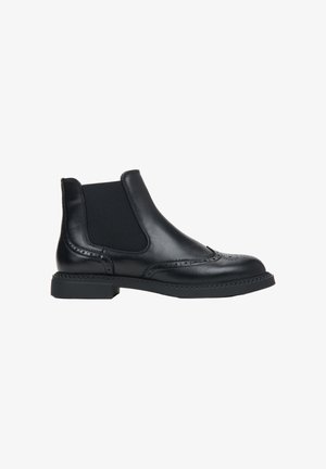 Black leather Chelsea boots featuring elastic side panels, brogue detailing, and a low block heel. Smooth texture and classic silhouette.