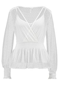 Blusa bianca in pizzo con maniche lunghe, scollo a V, vita peplo e polsini arricciati. Presenta intricati motivi floreali in tutto.