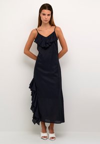 Tumesinine maxi kleit, millel on rippuvad detailid bodice'il ja külgedel. Sisse on ehitatud reguleeritavad spagetitripid ja sile, kerge kangas.