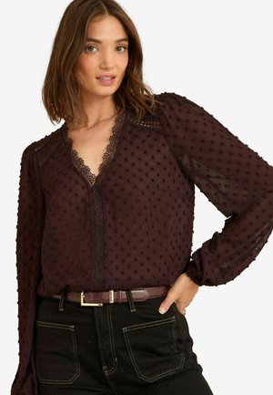 Burgundi blouse tekstuuriga kangast, puff-sleeve'idega ja pitsäärisega kaeluse ääres. Kandmisega pruun vöö ja mustad teksad.