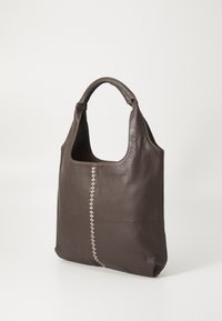 Brown leather tote bag with a smooth texture, curved handles, and a decorative stitch detail running vertically down the center.