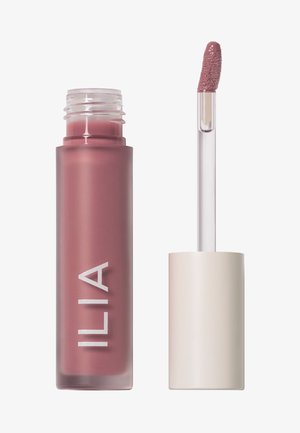 Lip product in a frosted mauve container with white lettering. Clear applicator wand with a soft, textured tip is next to the tube.